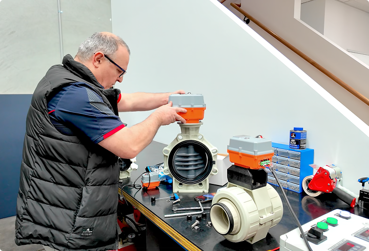 Fluidflo engineer attaching actuators to large pipe valves