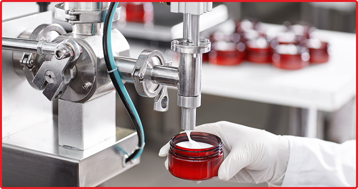 Cosmetic cream being piped into jar